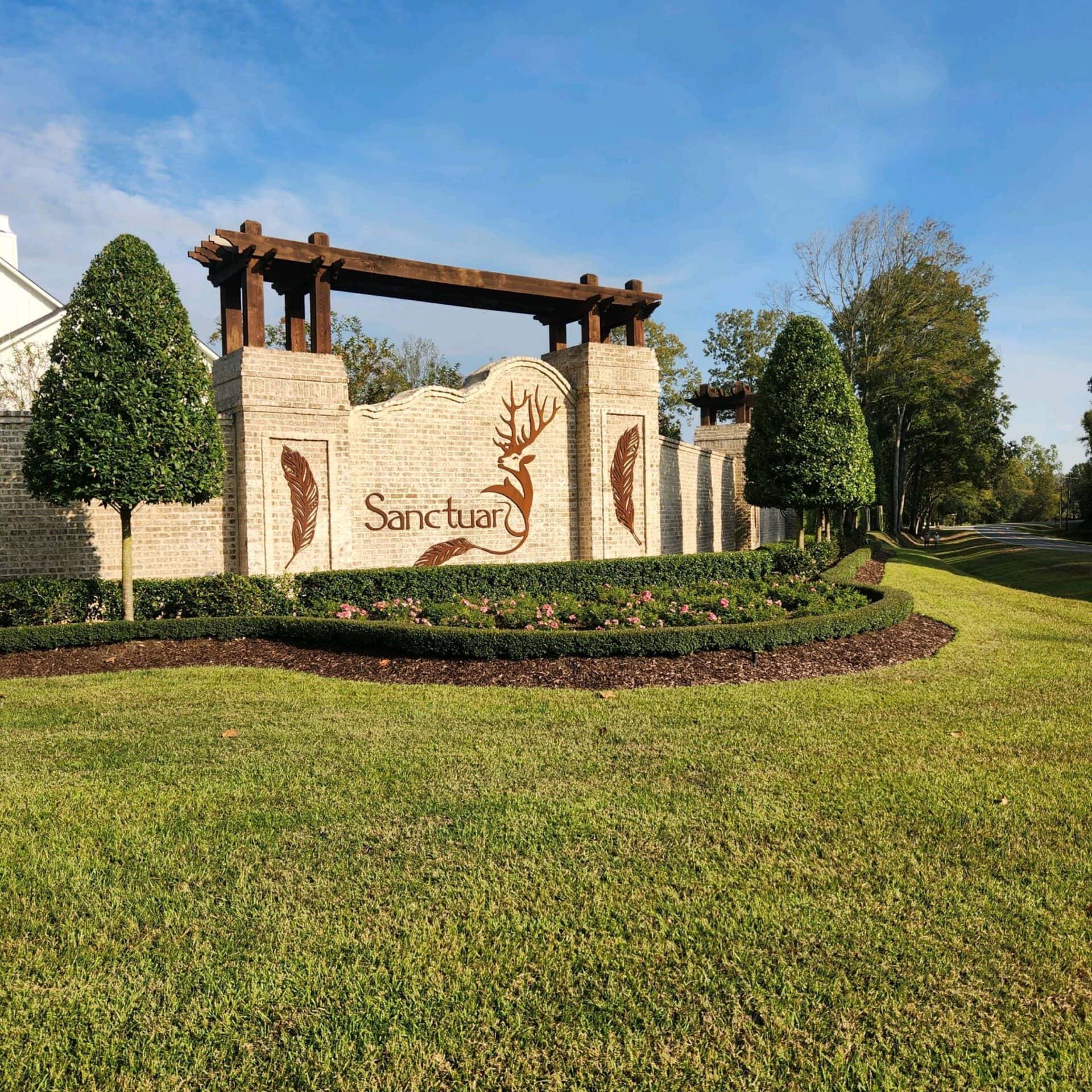 An elegant brick and stone entrance sign for a place called 